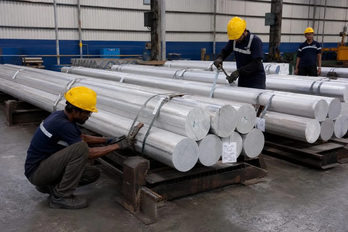 Workers strapping aluminium extrusion billet bundles on steel cradles with heat and alloy identity tags for ocean-freight export packaging
