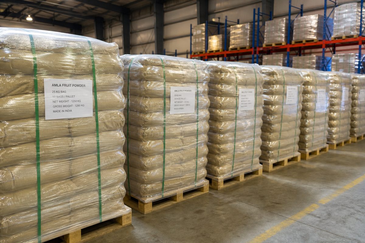 Palletized bags of Indian amla powder staged on dry warehouse racks before port dispatch