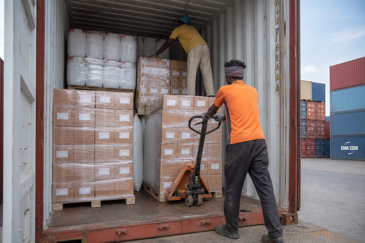 Leak-protected stuffing of Ayurvedic hair oil bottle cartons and HDPE jerricans into a 20-foot export shipping container