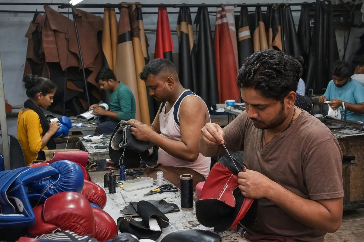 Workers stitching boxing gloves and assembling punch bag shells in a Jalandhar sports goods factory
