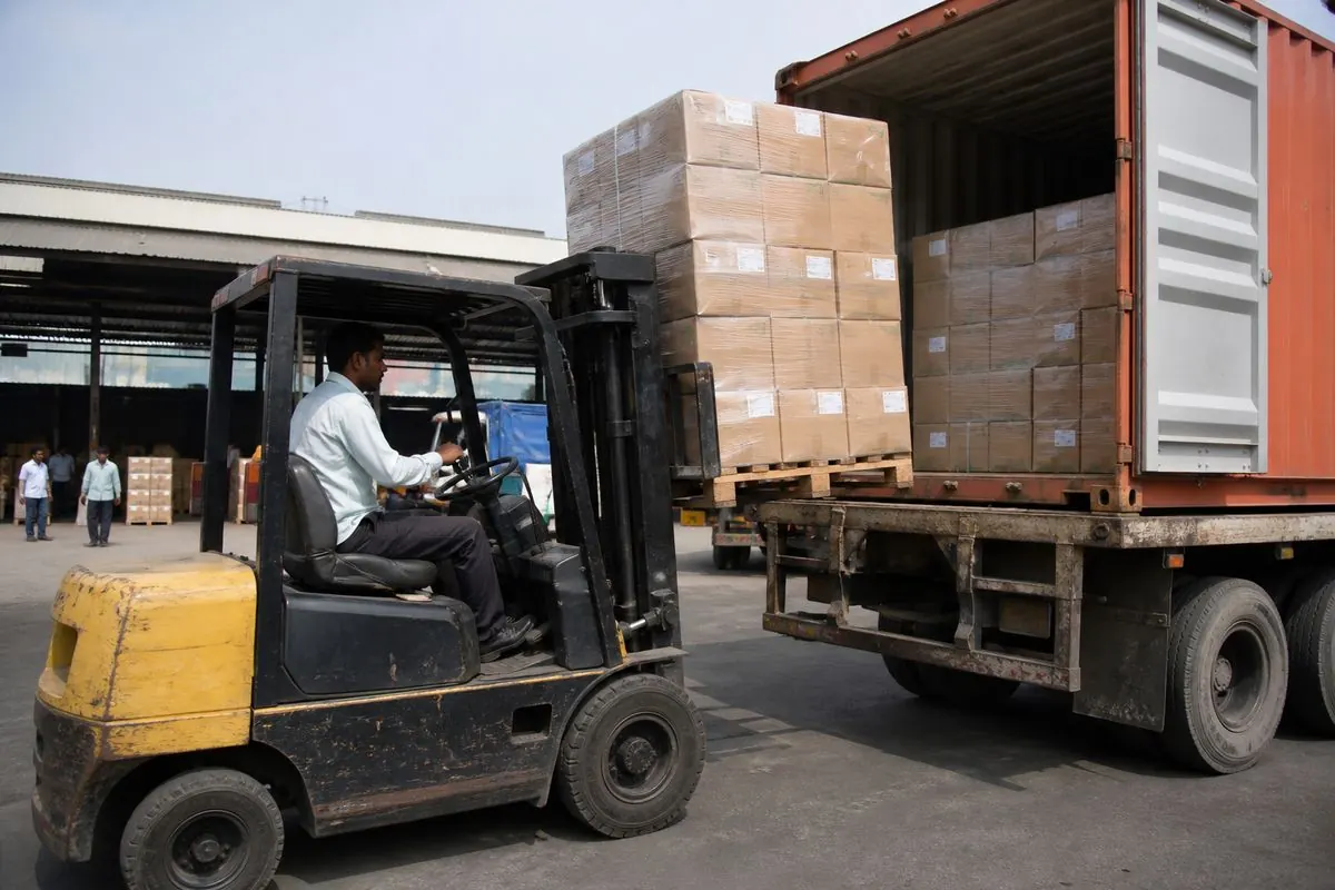 Forklift loading palletised dried vegetable cartons onto a truck bound for Mundra port