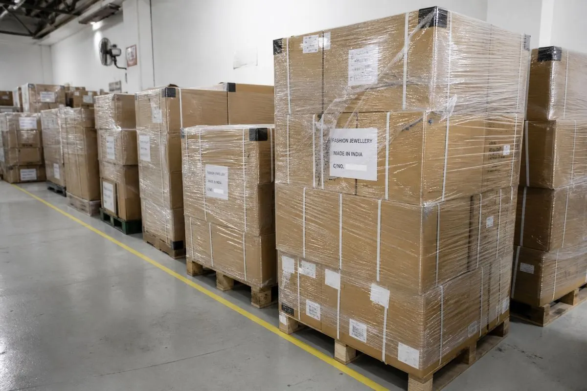 Palletized stretch-wrapped cartons of Indian fashion jewellery export stock in warehouse aisle