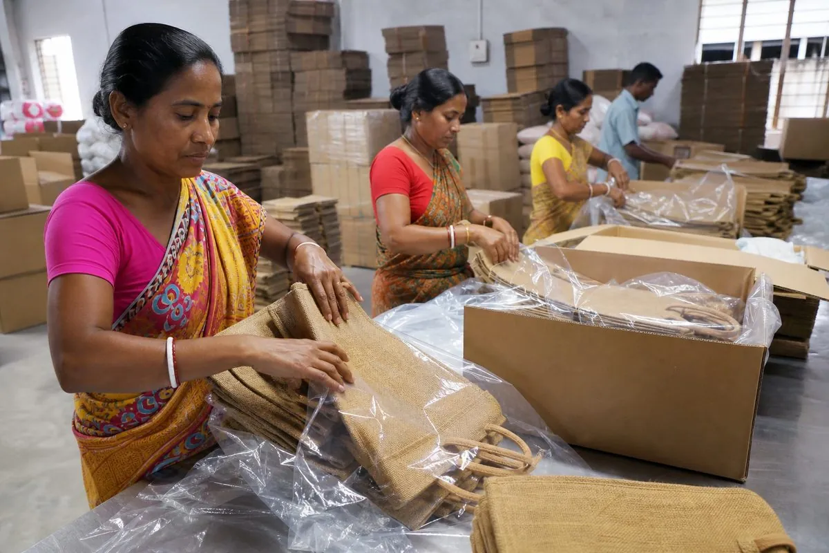 Workers packing Indian jute shopping bags into moisture-protected corrugated export cartons with desiccants