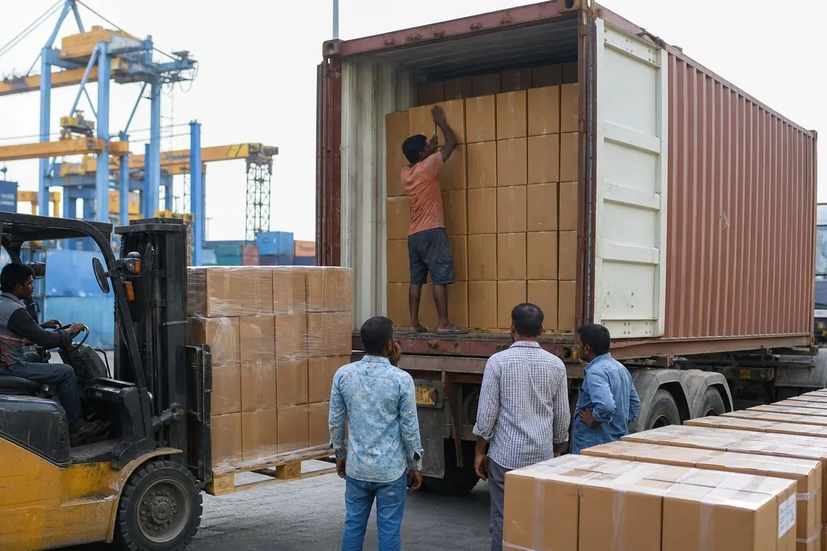 Shipping container stuffing with perfume master cartons at Indian export port terminal