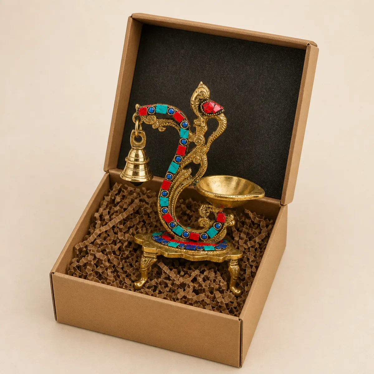 Brass peacock gemstone diya packed in a kraft gift box with foam for export