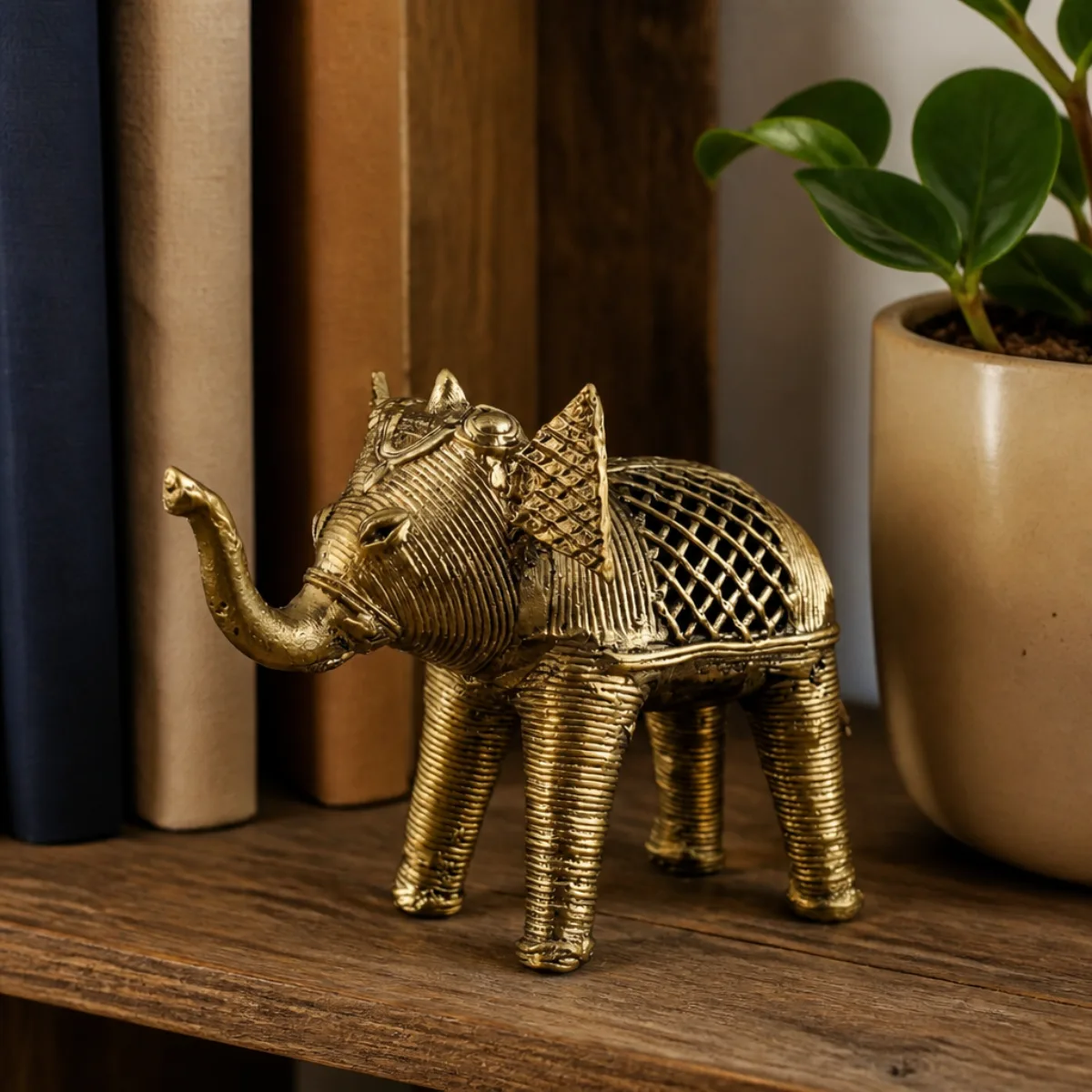 Dhokra brass elephant used as bookshelf décor among books