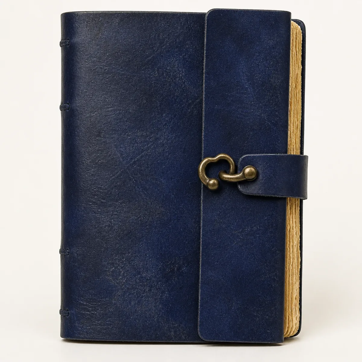 Closed navy-blue leather journal with antique brass C-hook clasp