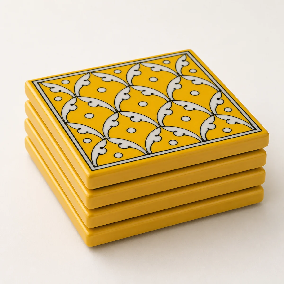 Stacked square Jaipur Blue Pottery yellow jaal coasters showing glazed edge profile