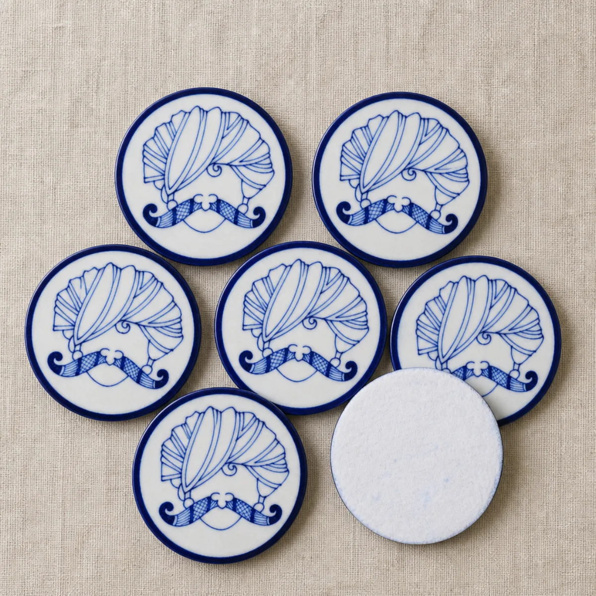 Felt backing on the underside of a Jaipur Blue Pottery coaster to protect furniture