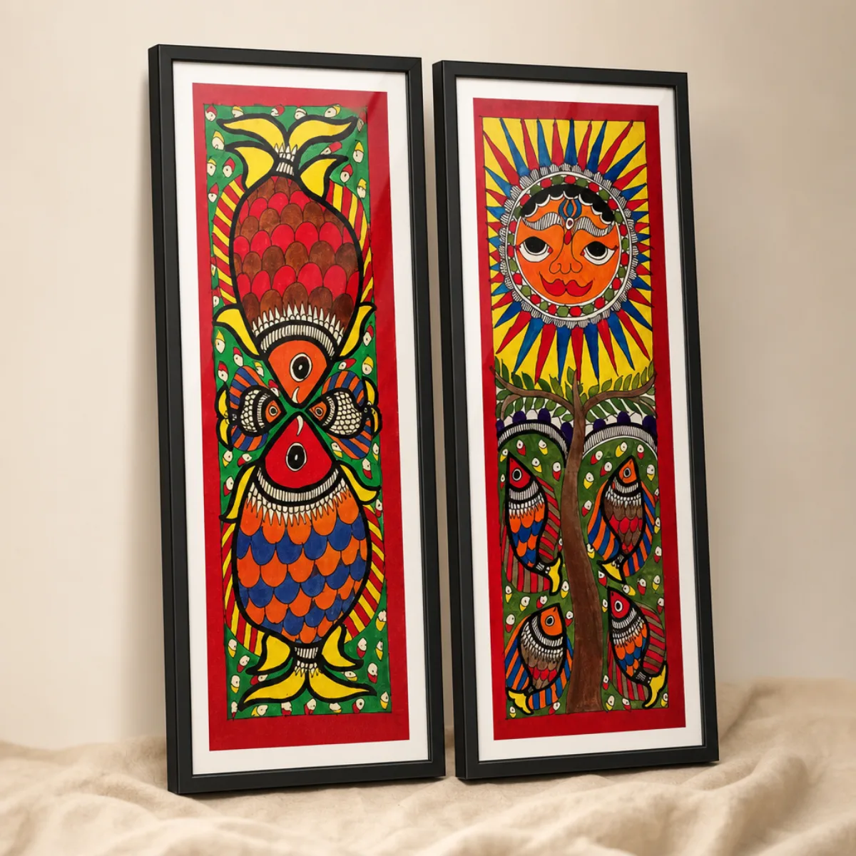Angled view of two framed Madhubani paintings showing slim black frames and white mats