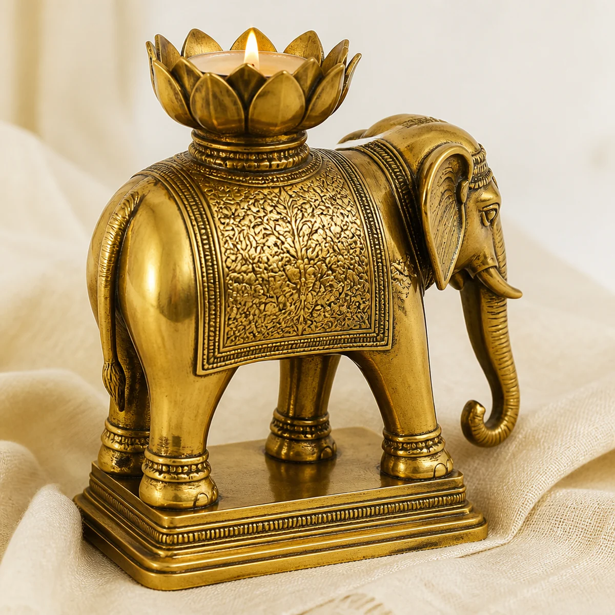 Side and back view of a handmade Moradabad brass elephant candle holder from India