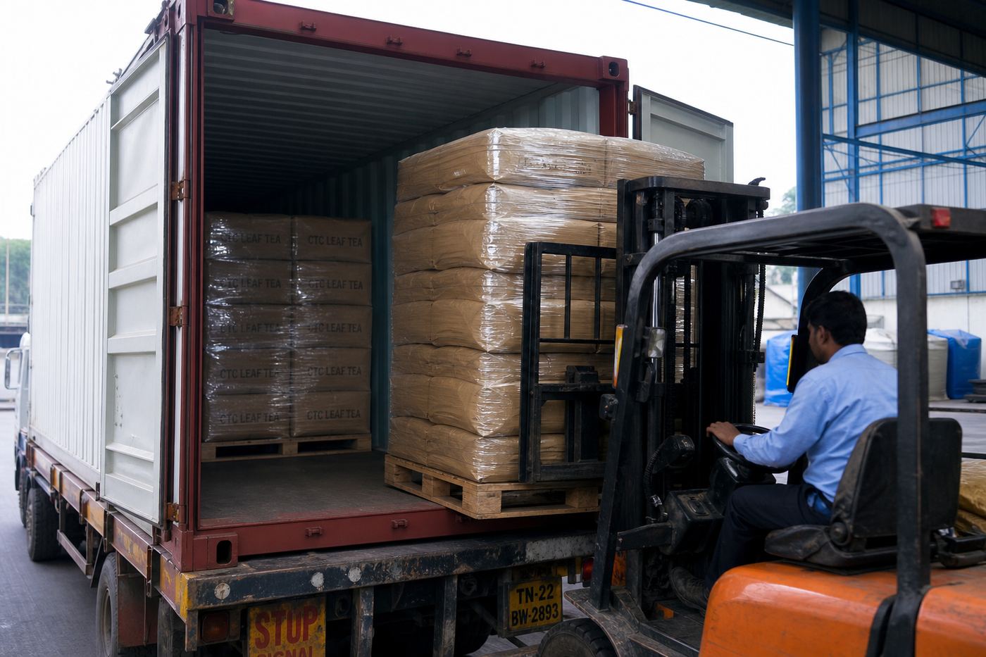 Forklift stuffing palletized kraft bags of Indian tea into a 20-foot shipping container for FCL export