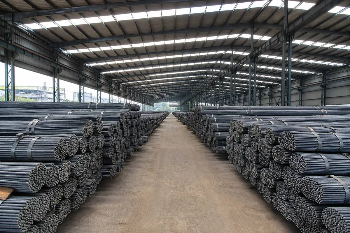 Rows of strapped TMT bar bundles stacked in a dry Indian export yard before dispatch to Mundra, Nhava Sheva, Paradip, or Vizag
