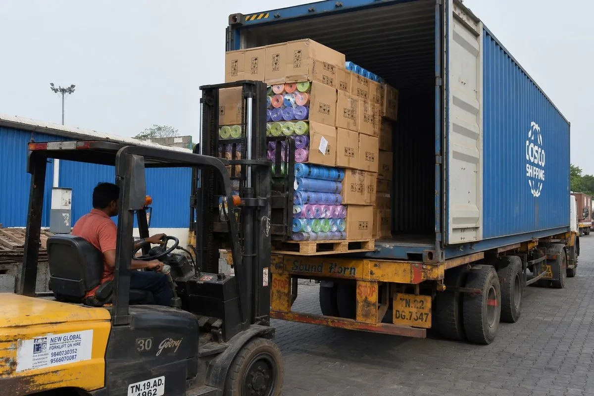 Forklift stuffing palletized cartons of Indian yoga mats into a shipping container for FCL export