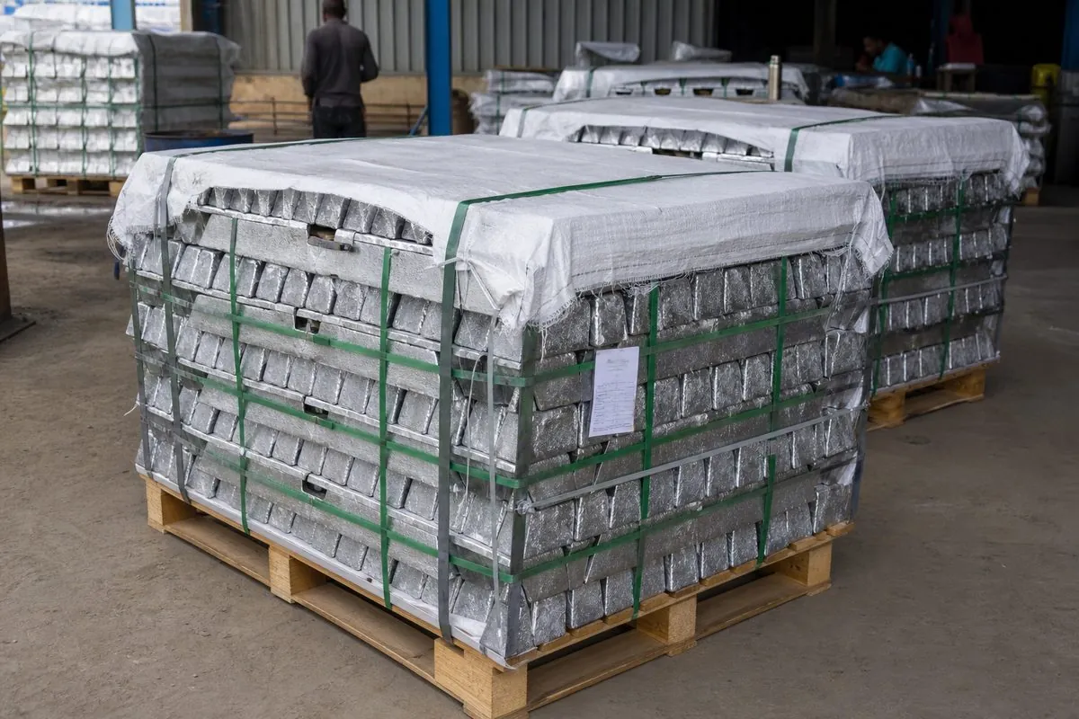 Workers strapping zinc ingot bundles on wooden pallets with lot tags for ocean-freight export packaging